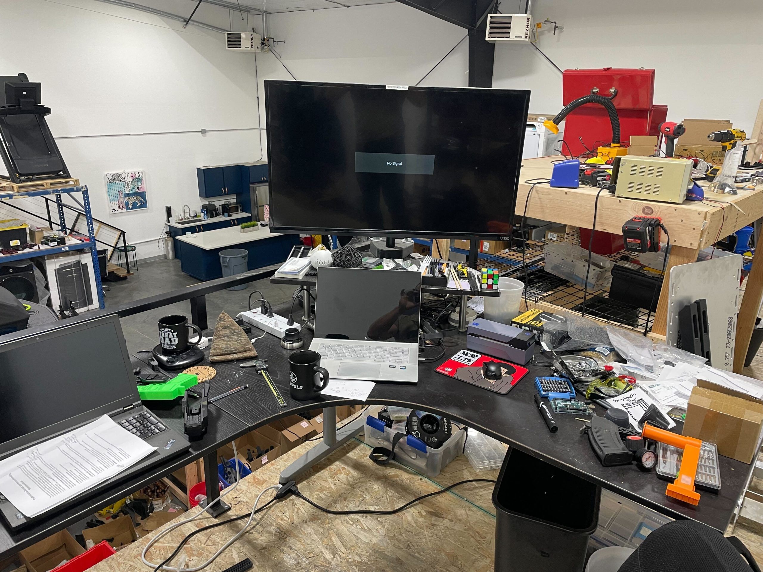 desk with a monitor and various items on top
